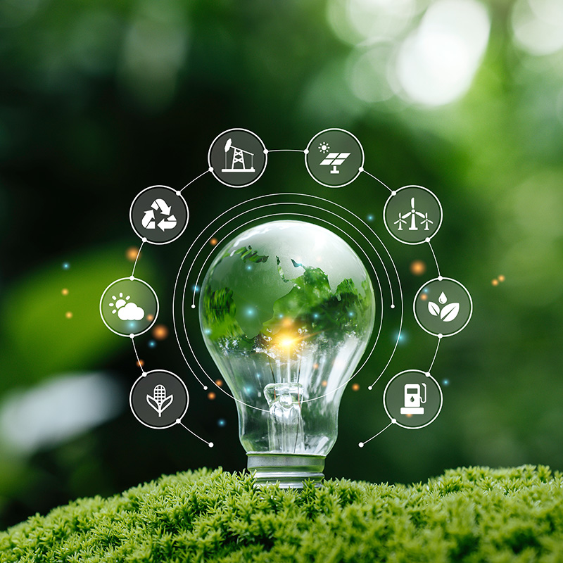Stock image of energy ecosystem showcased around an electric bulb with a green background