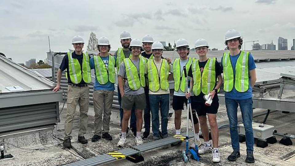 Georgia Tech Students with SEI's Rich Simmons engaged in the Rooftop Solar Panel Cleanup Volunteer project