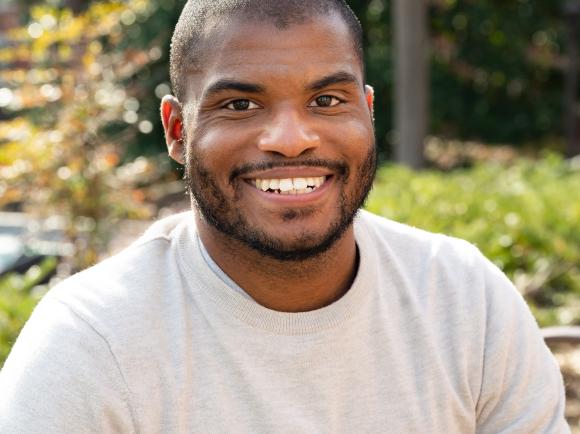 Smiling man sitting outside