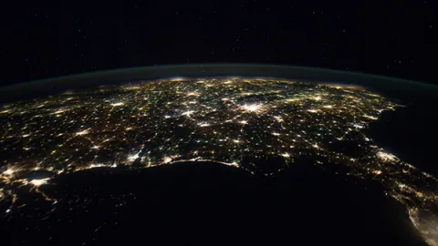 Earth at night, showing the USA with city lights