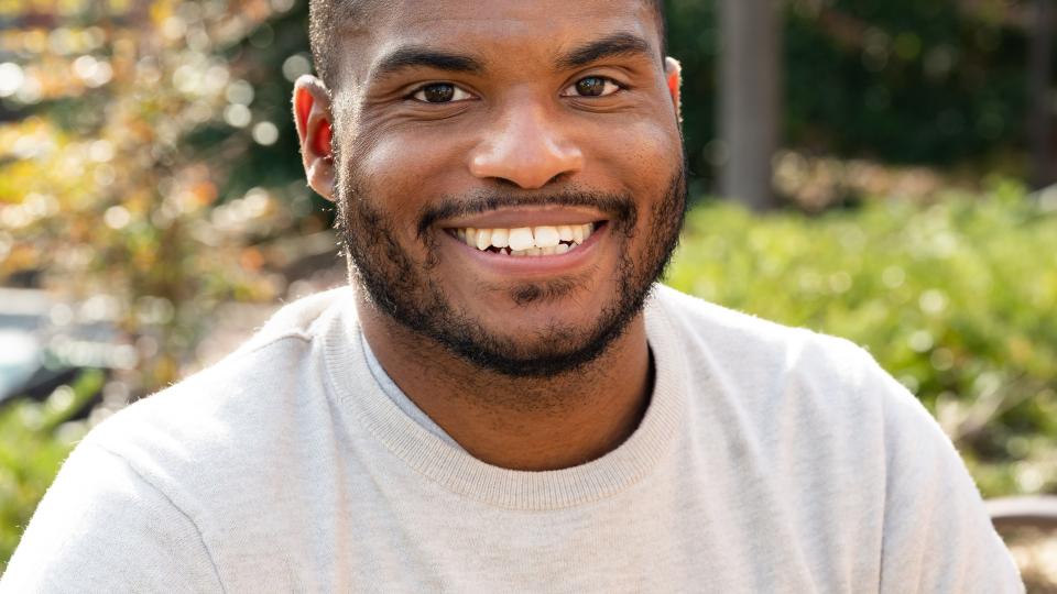 Smiling man sitting outside