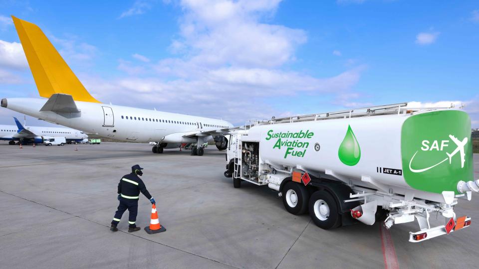 Fuel Truck carrying Sustainable Aviation Fuel near an airplane